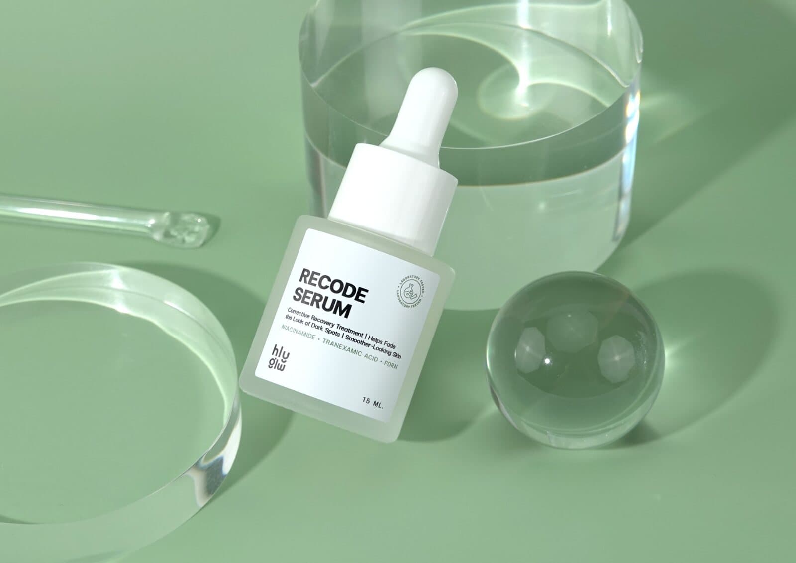 HLY GLW RECODE Serum bottle on a soft sage set